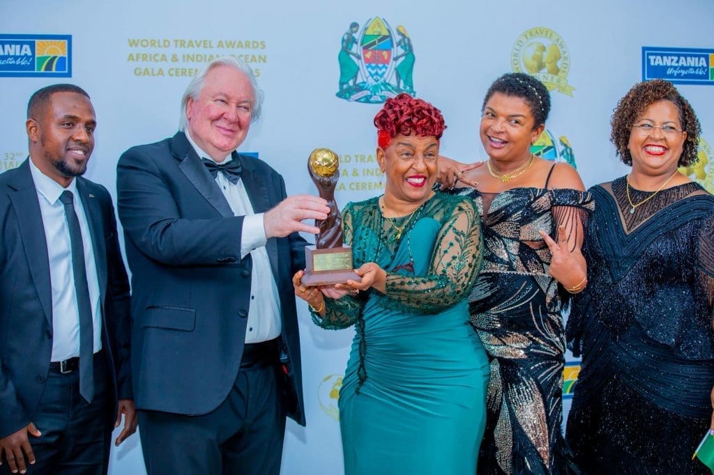 Mama Zara receiving the World Travel Award 2025 for Africa’s Leading Adventure Tour Operator, smiling with her team at the gala ceremony.